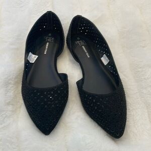 Black studded flats with pointed toes.